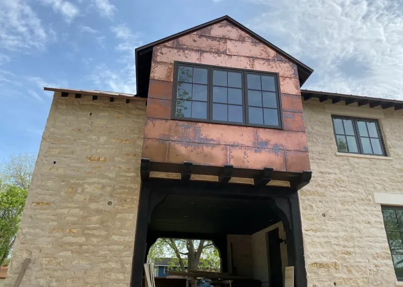 Copper metal panel facade on a stone building for Skylight Installation in Lockport